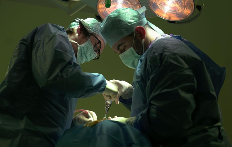 Surgeons performing surgery at The Walton Centre in Liverpool
