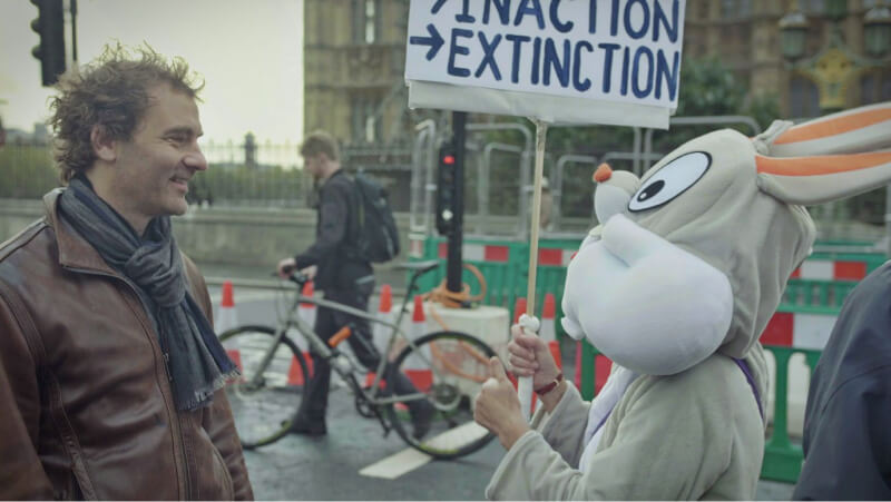 Filmmaker Josh Appignanesi talking to a climate activist dressed as Bug’s Bunny at an Extinction Rebellion protest