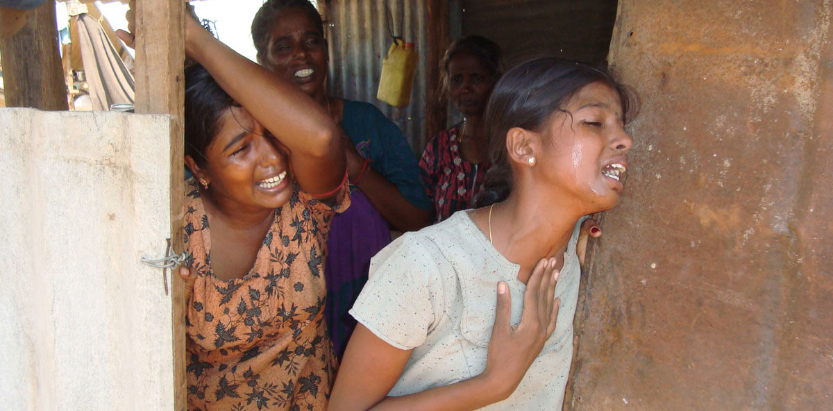 Close-up of three female victims of Sri Lanka’s Civil War in extreme distress